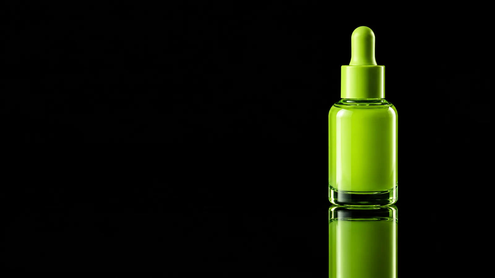 A single lime green dropper bottle standing on a reflective surface against a solid black background.